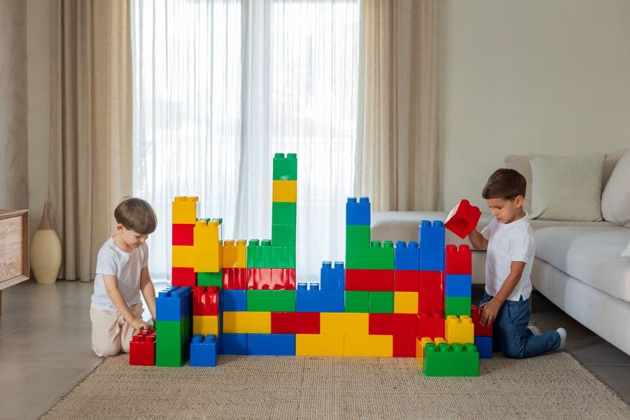 Young children playing with colorful building blocks
